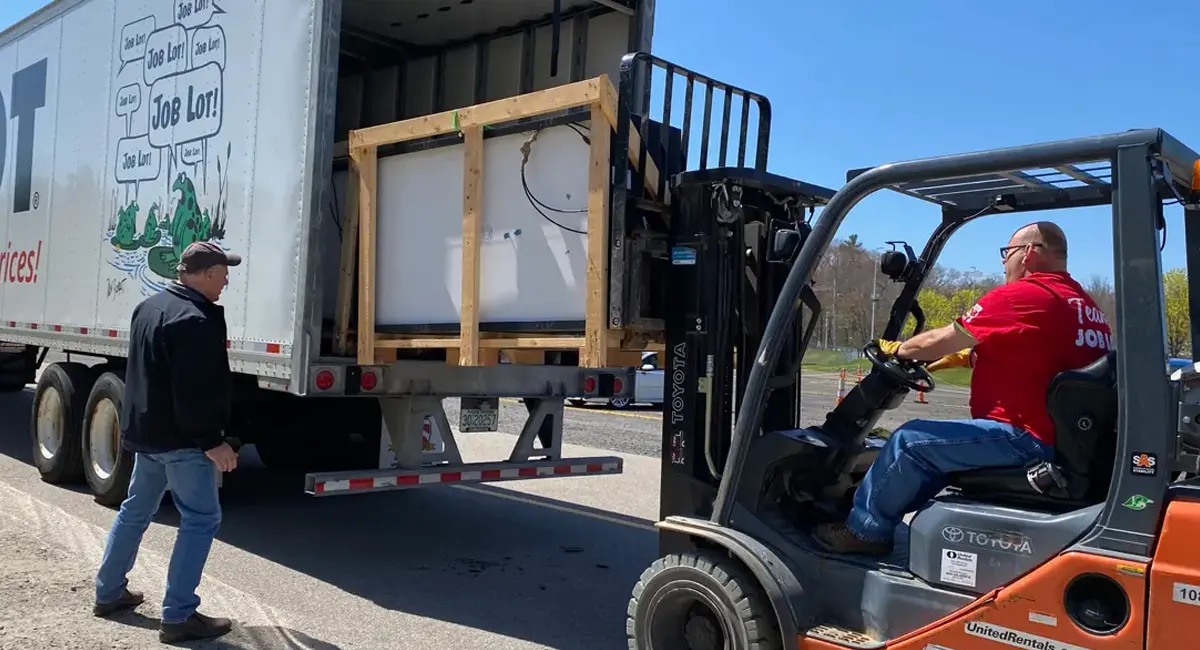 David Sarlitto, Executive Director, Ocean State Job Lot Charitable Foundation, directs Mike Beach, a driver for OSJL, as he loads the solar panels into OSJL’s tractor-trailer that delivered 250 solar panels to Erie, Pennsylvania on Thursday, April 20th.