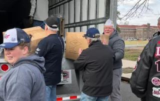 Local volunteers unload boxes filled with winter coats that were distributed to local veterans and families in need in the Philadelphia area.