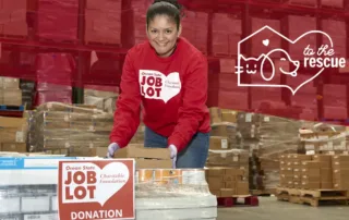 Ocean State Job Lot associate leaning over pallet of pet food for donation