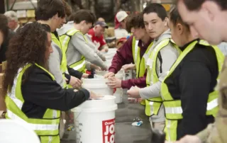 Ocean State Job Lot associates and volunteers helping stuff buckets or kindness for veterans in need.